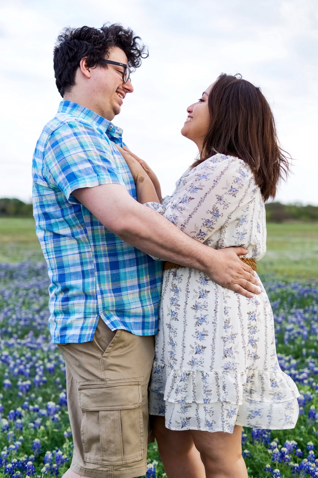 Nicholas and Andrea looking at each other in a Texas bluebonnet field